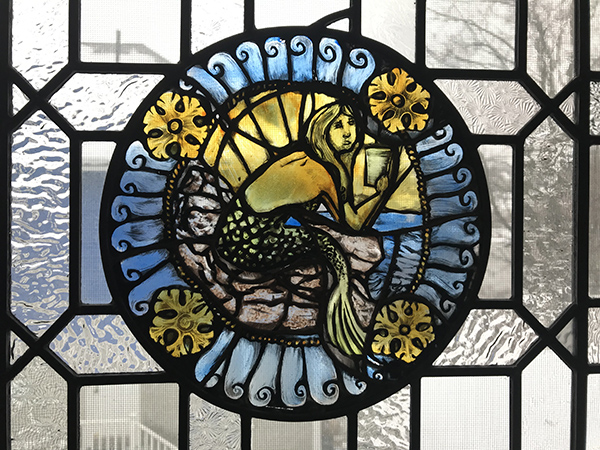 Mermaid on rocks stained glass